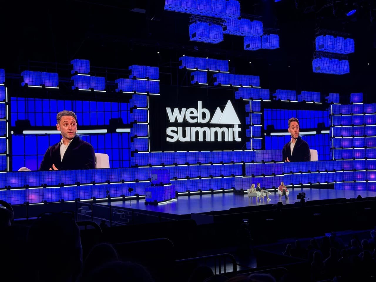 Wide view of Web Summit main stage with massive screens and impressive production setup